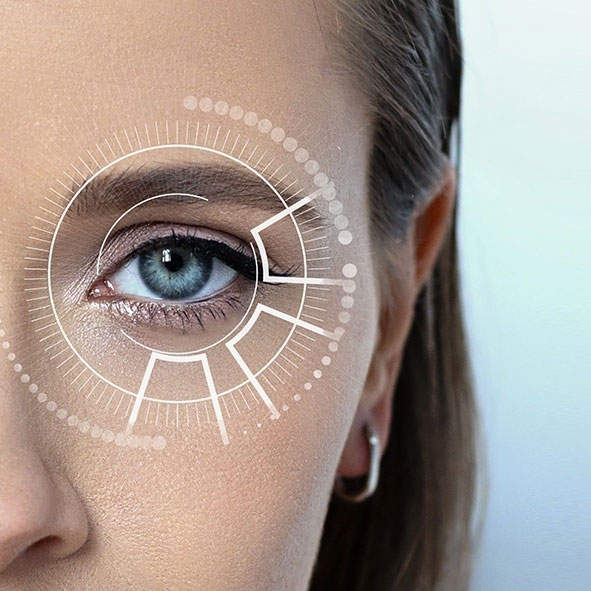 Close-up of a woman's eye with a digital interface overlay, representing vision correction technology or laser eye surgery.